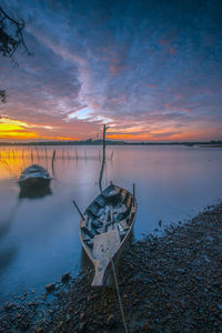 Scenic view of lake against sky during sunset