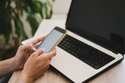 High angle view of person using laptop on table