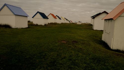View of grassy field against cloudy sky