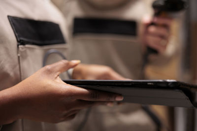 Midsection of man using mobile phone