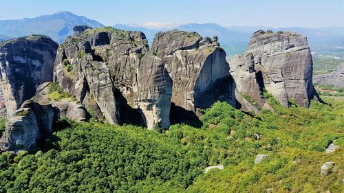 Panoramic view of meteora rocks on landscape against sky