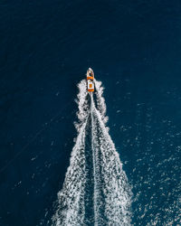 High angle view of person paragliding on sea