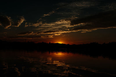 Scenic view of silhouette trees against sky at sunset