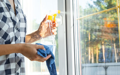 Low section of man cleaning window