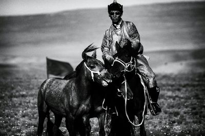 Man riding horse on field