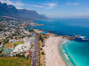 High angle view of city by sea against sky