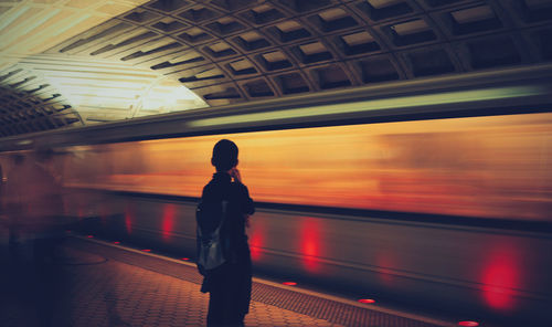 Woman standing at sunset
