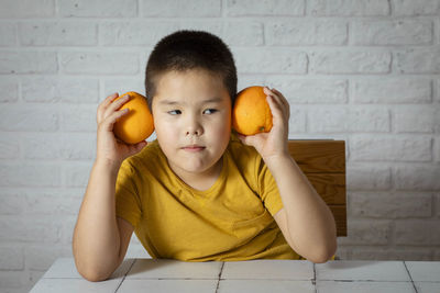 Little citrus connoisseur, embracing vitamin c with joyful juicy oranges