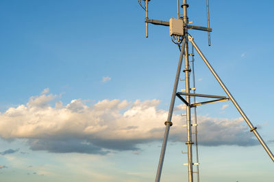 Low angle view of crane against sky