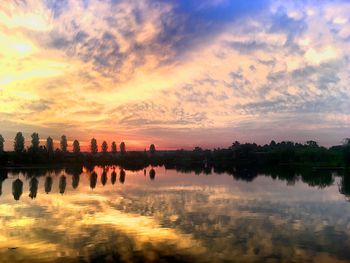 Reflection of clouds in sea at sunset