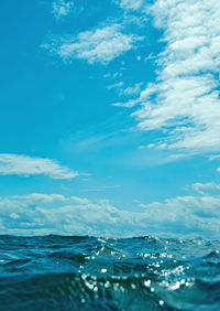 Surface level of sea against blue sky