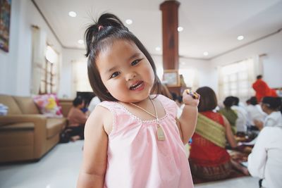 Portrait of happy girl standing in corridor