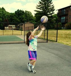 Girl playing ball in playing field