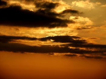 Low angle view of cloudy sky at sunset