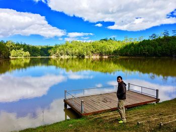 Rear view of man on lake against sky