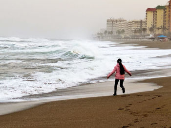 Full length of woman walking on beach