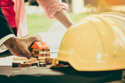 Cropped hands of people working on table