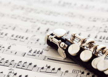 Close-up of woodwind instrument on sheet music