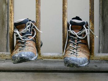 Close-up of old shoes on wooden post