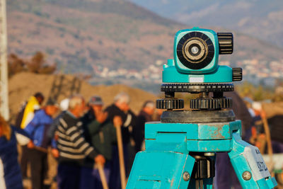 Optical level on a blurred background with workers working on a archaeological site