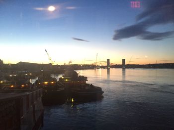 View of city at waterfront during sunset