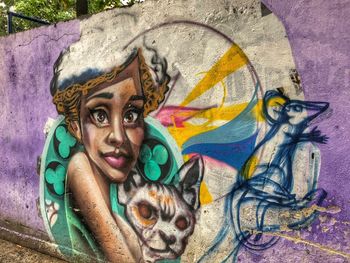 Portrait of multi colored graffiti on wall