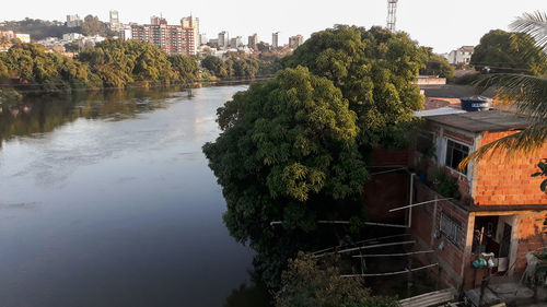 River amidst trees and buildings against sky