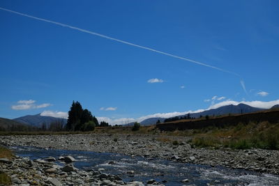 Scenic view of landscape against blue sky