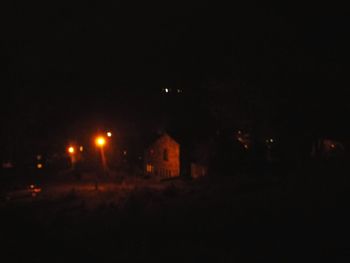 Illuminated building against sky at night