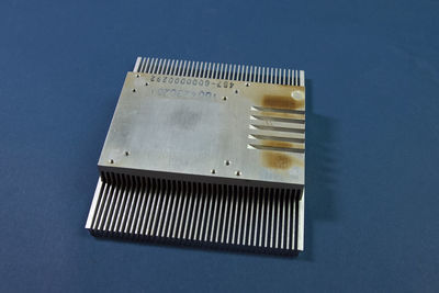 High angle view of camera on table against blue background