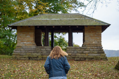 Rear view of boy standing in field