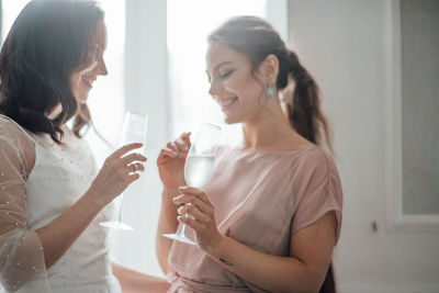 Young woman drinking glass at home