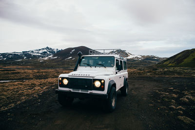 Car on mountain road against sky