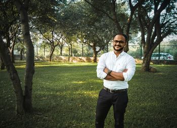 Portrait of smiling young man standing on land