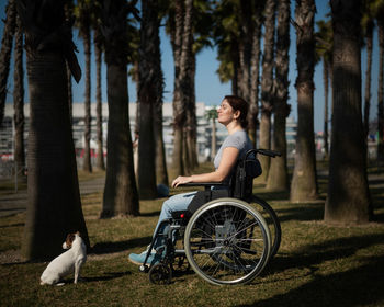 Rear view of woman riding bicycle on field