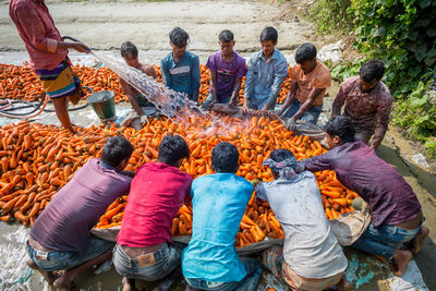 High angle view of people sitting on ground