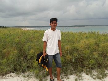 Portrait of young man standing on land