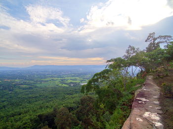 Scenic view of landscape by sea against sky