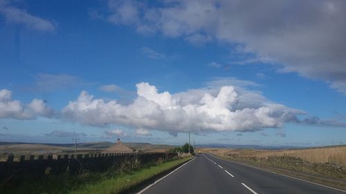 Empty road along countryside landscape