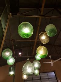 Low angle view of illuminated lights hanging from ceiling