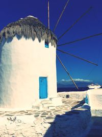 Built structure on beach against clear blue sky