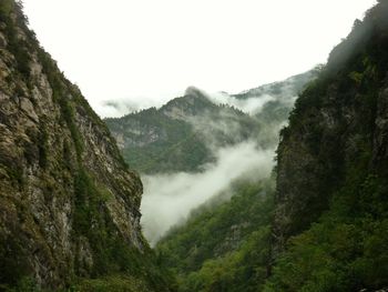 Scenic view of mountains against cloudy sky