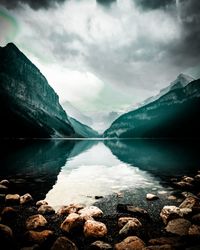 Scenic view of lake and mountains against sky