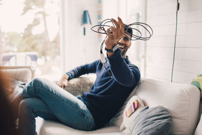 Man sitting on sofa at home