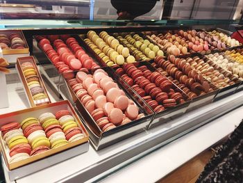 High angle view of macaroons in containers for sale