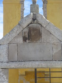 Low angle view of cross against sky