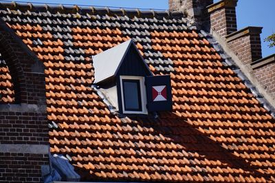 Low angle view of building roof against sky