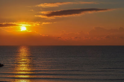 Scenic view of sea against orange sky