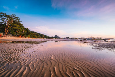 Scenic view of beach against sky during sunset