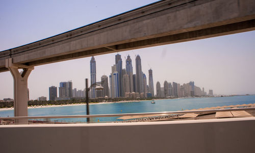 View of city by sea against sky